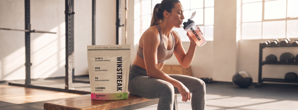 Athlete tearing open a Winstreak stick pack in a sunlit gym